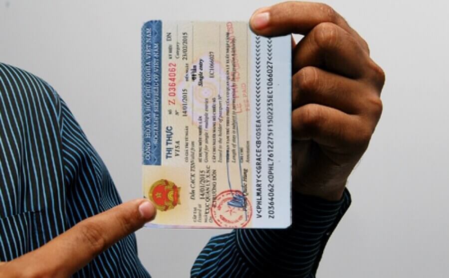 A man shows the logo of vietnam visa with his finger