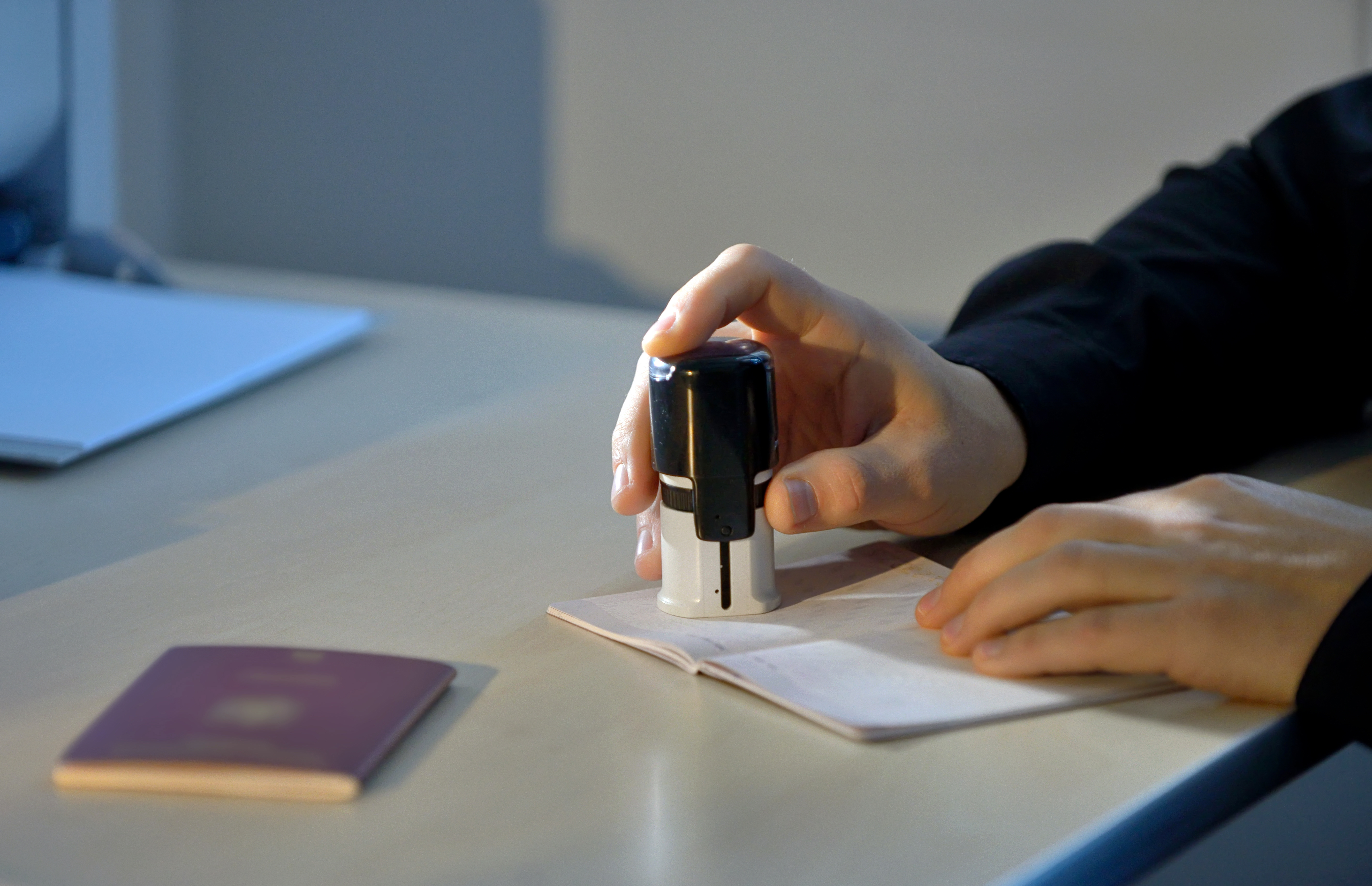Customs Officer Stamping a Passport