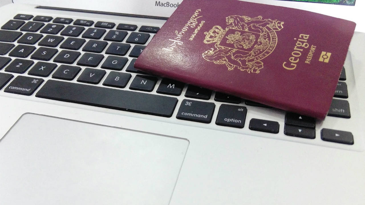 Georgia passport placed on the Laptop