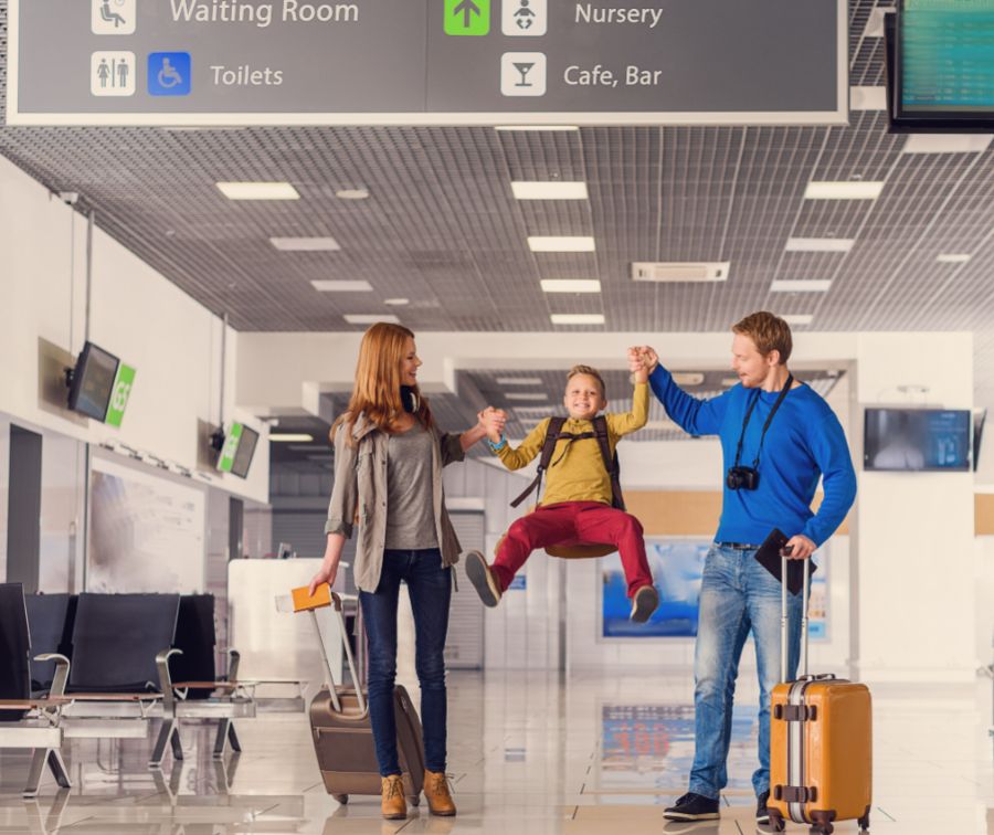 Happy family with kid in airport with Luggages