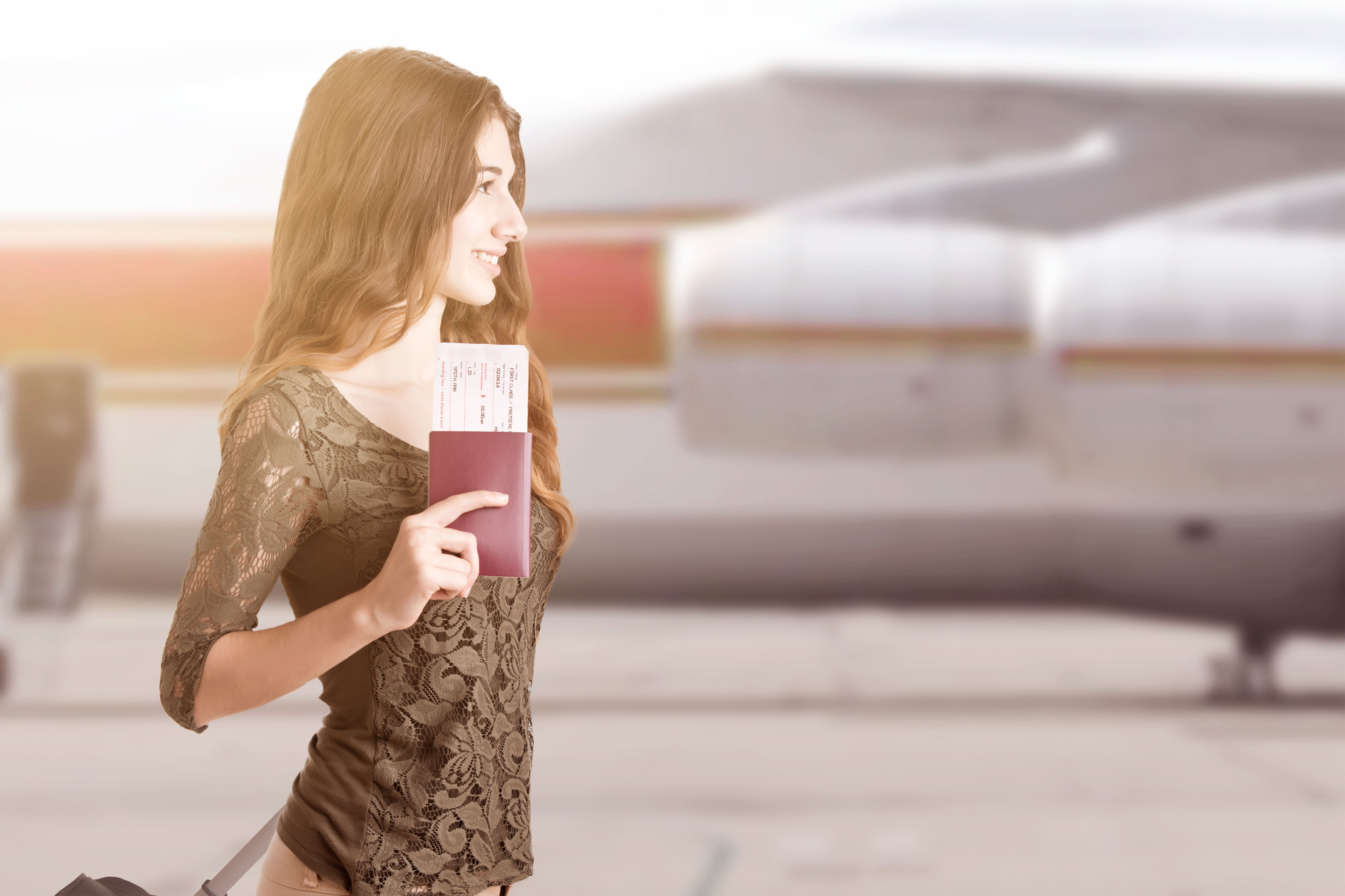 Woman about to board an airplane with passport