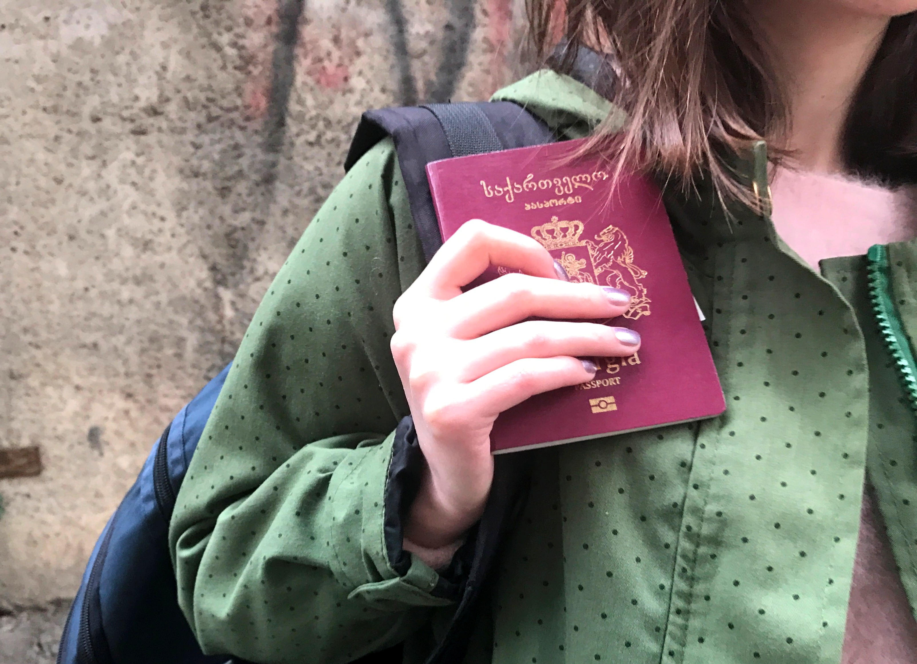 Women holding the Georgia passport