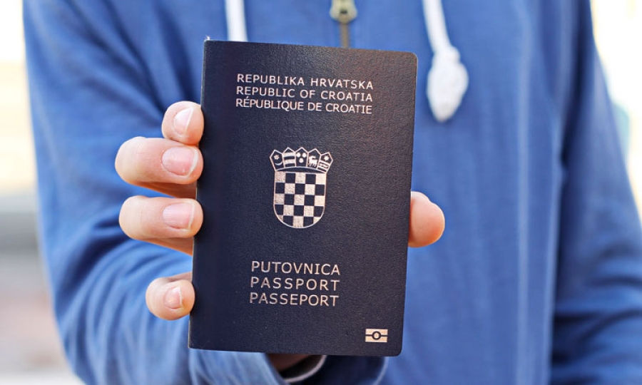 Blue Tshirt Man with Croatia Citizen Passport in hand