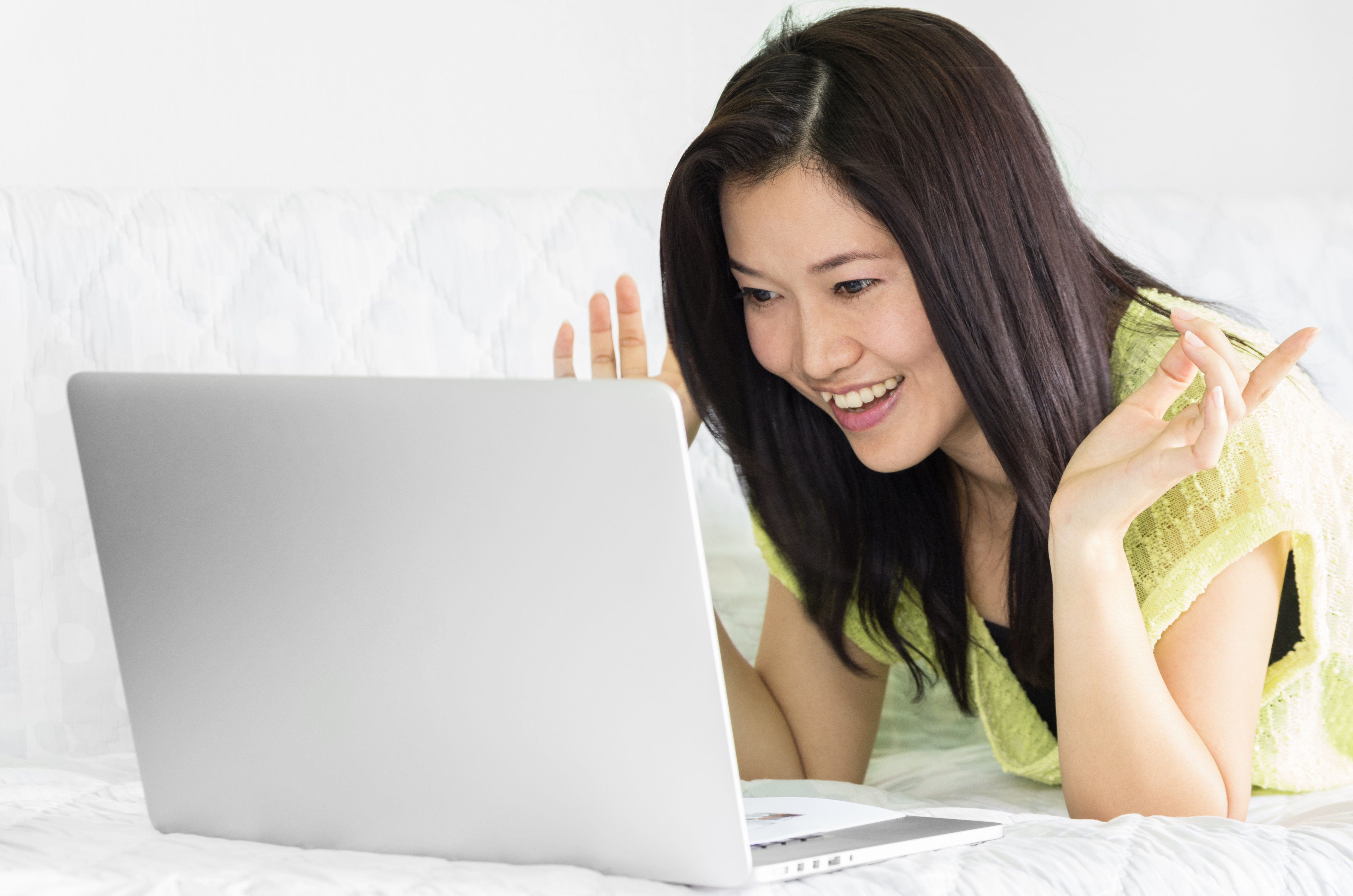 Happy young beautiful woman using laptop for applying vietnam Visa