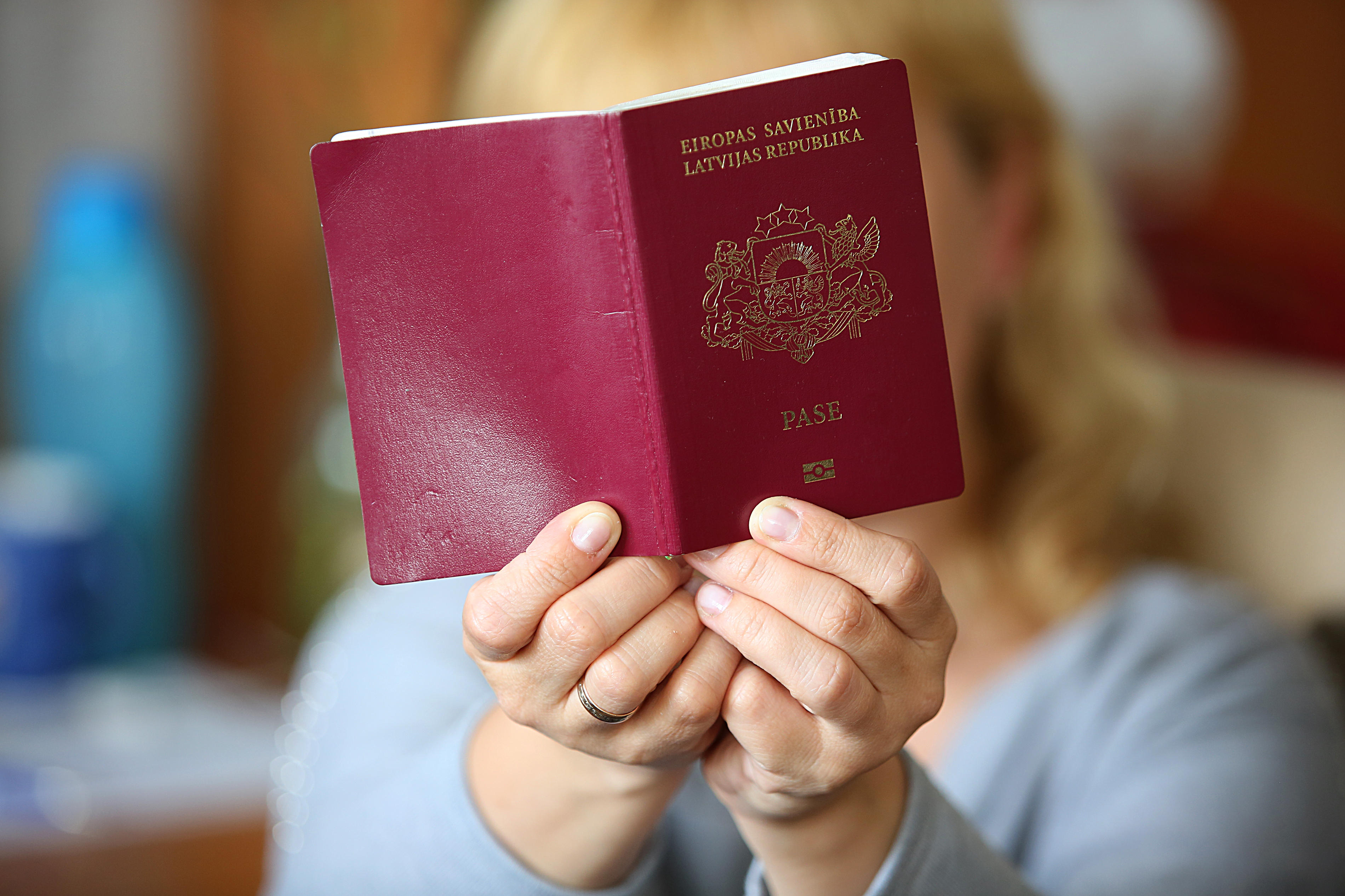 Woman holds latvia passport